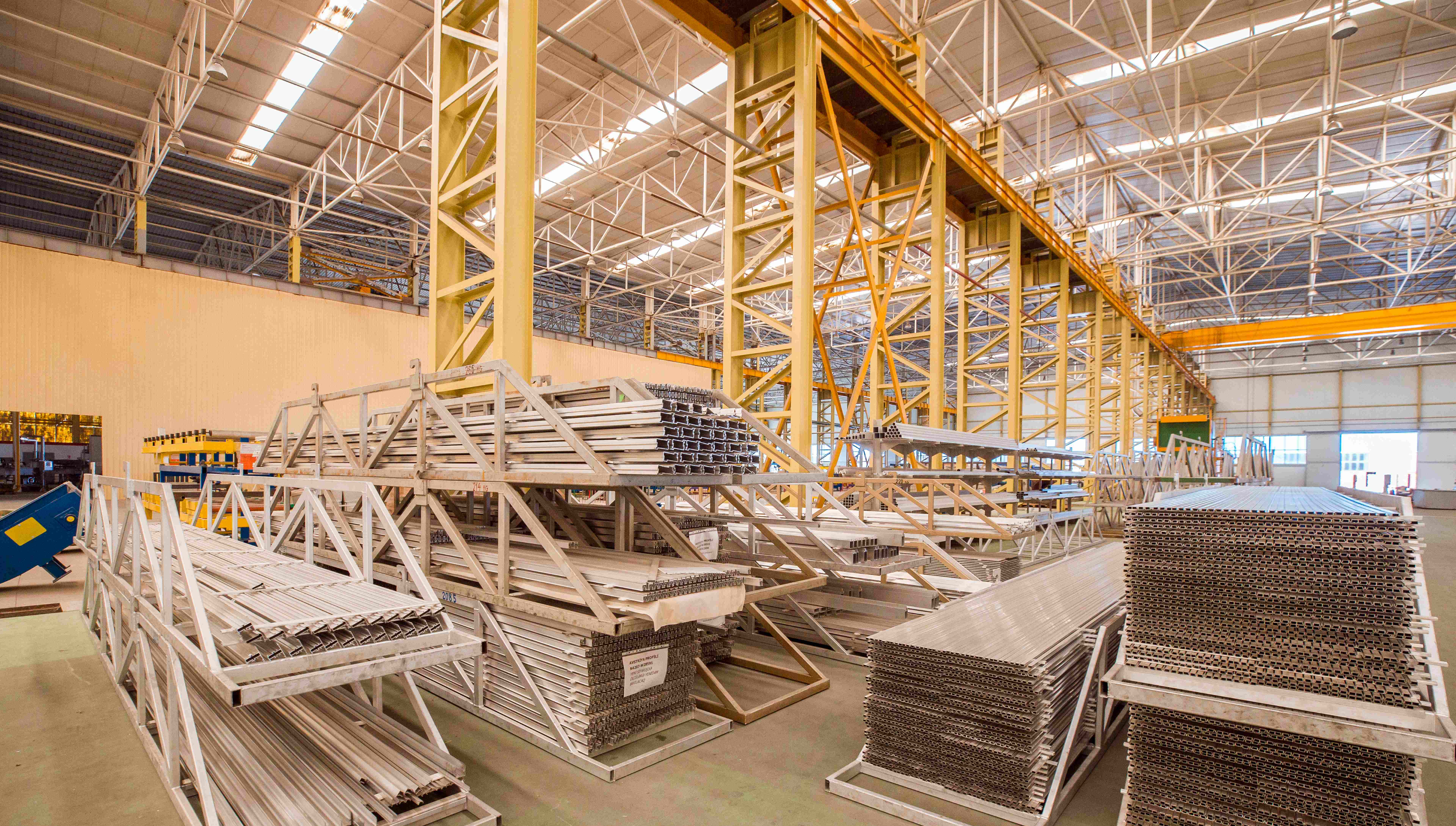 Steel manufacturing facility with stacked metal profiles and sheets